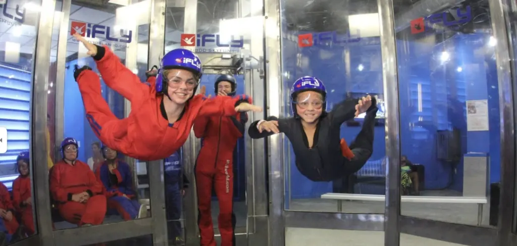 two kids floating in mid air indoor skydiving