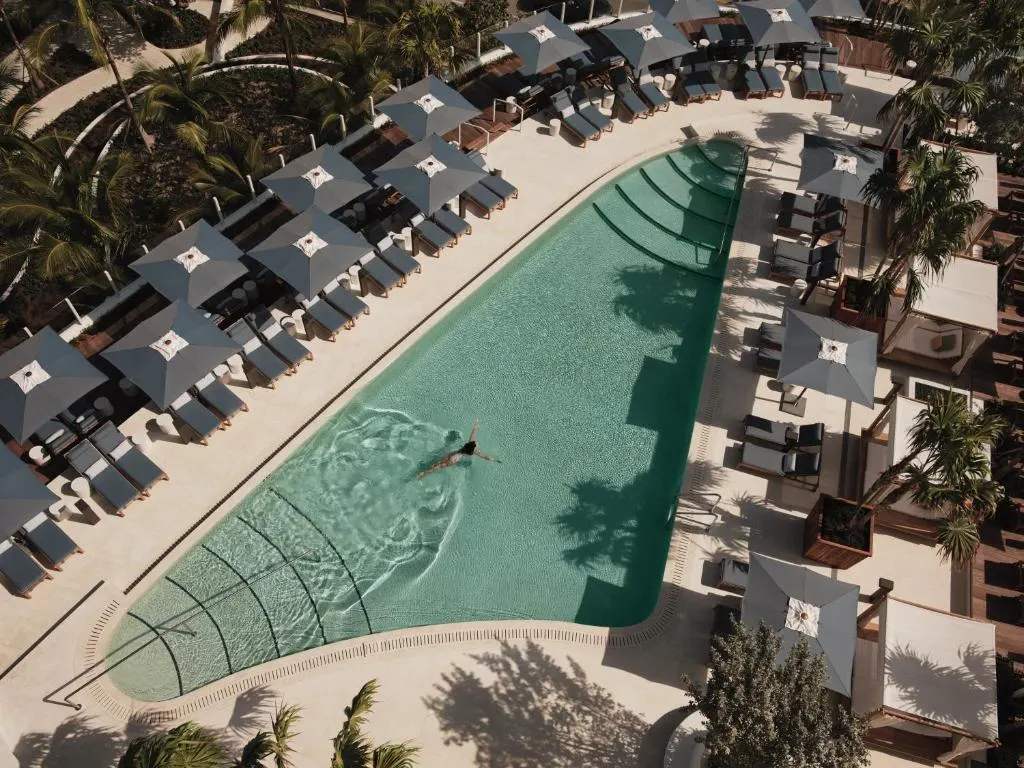 Outdoor pool, trees, and deck chairs at four seasons fort lauderdale