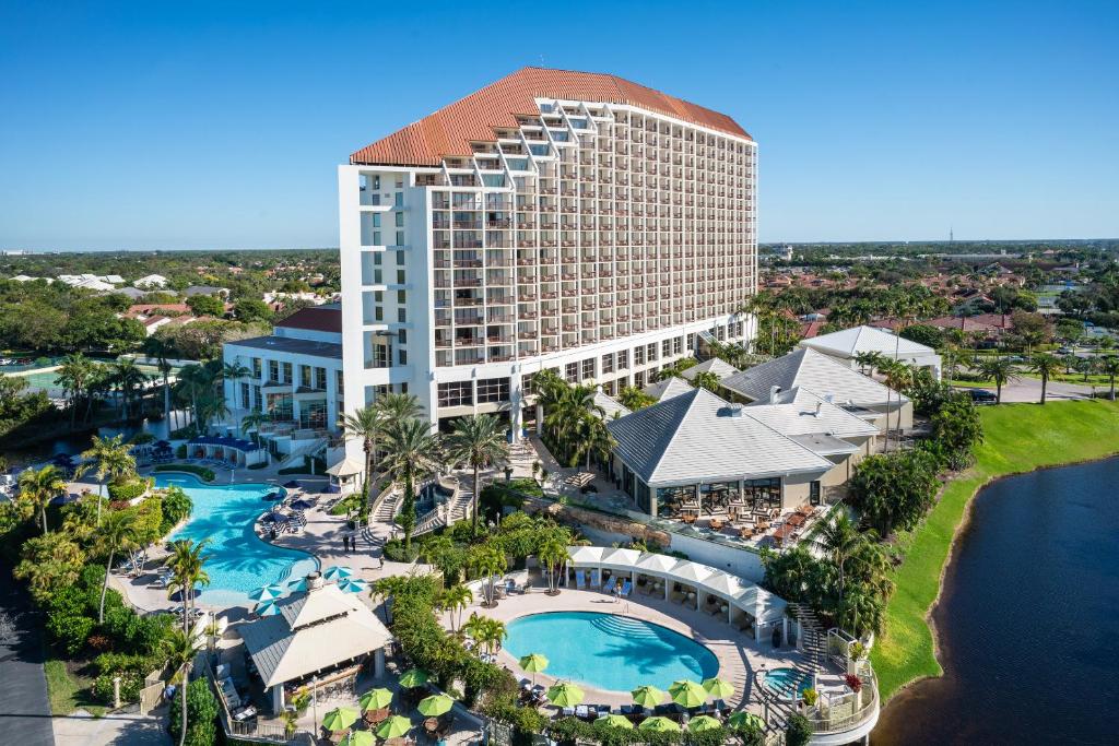 The main tower and outdoor swimming pools of Naples Grande Beach Resort in Naples, Florida