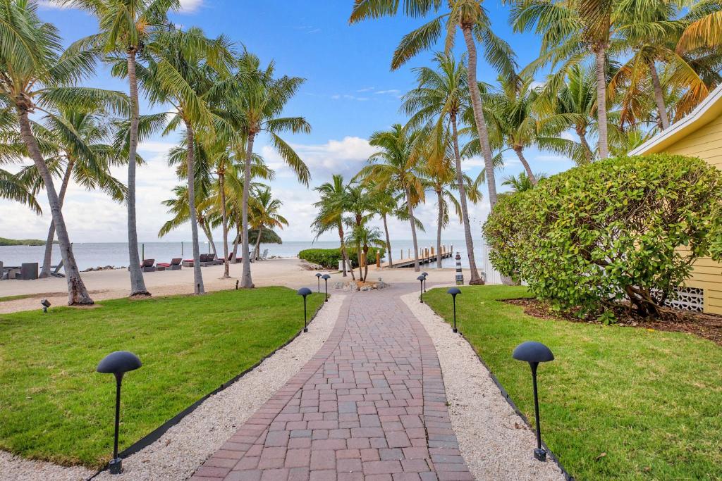 A path lined with palm trees leads to the beach at Atlantic Bay Resort Key Largo