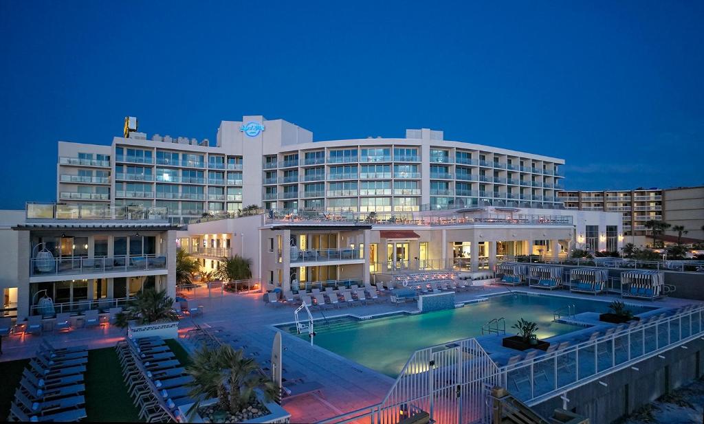 Evening view of the outdoor pool and main building of the Hard Rock Hotel in Daytona Beach