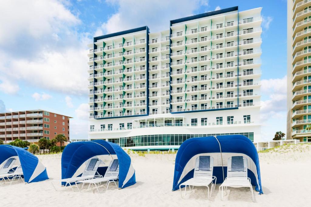Covered beach chairs on the beach in front of Hyatt Place Panama City Beach