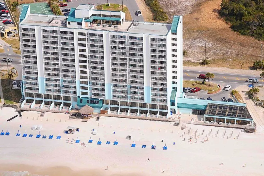 Aerial view of the beach next to Landmark Holiday Beach a VRI resort in Panama City Beach
