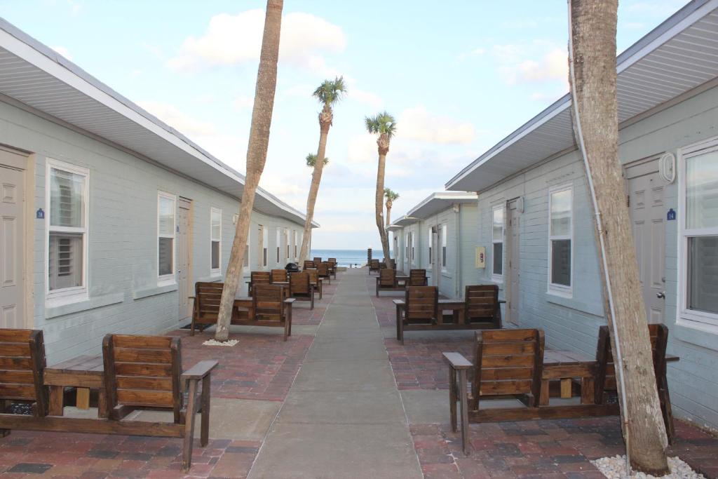 View of some of the cabins at Shoreline Suites Cabana Cottages, with chairs and palm trees out front