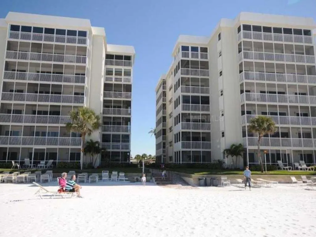 The condo towers of Crescent Arms Condominiums stand by the beach in Siesta Key